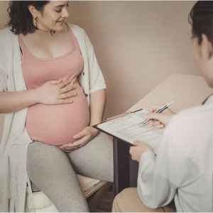 Pregnant woman receiving prenatal care from doctor at Seva Clinic