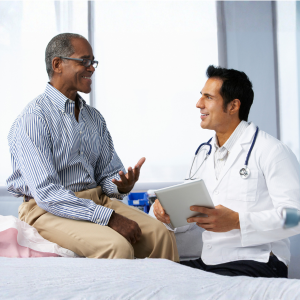Doctor consulting male patient about sexual health at Seva Clinic